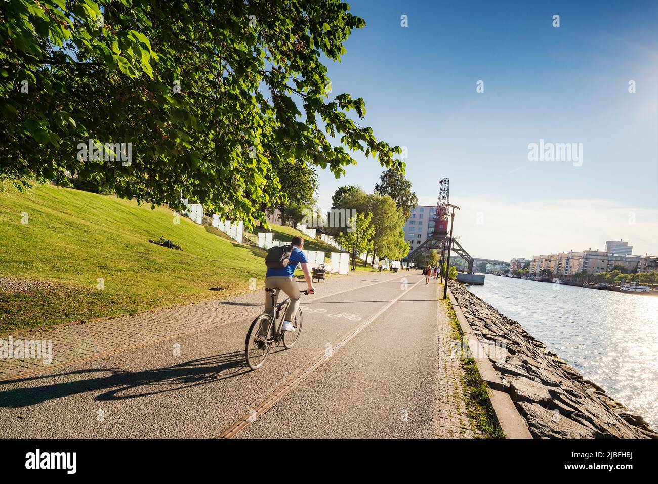 Cyclist by waterfront in Stockholm, Sweden Stock Photo