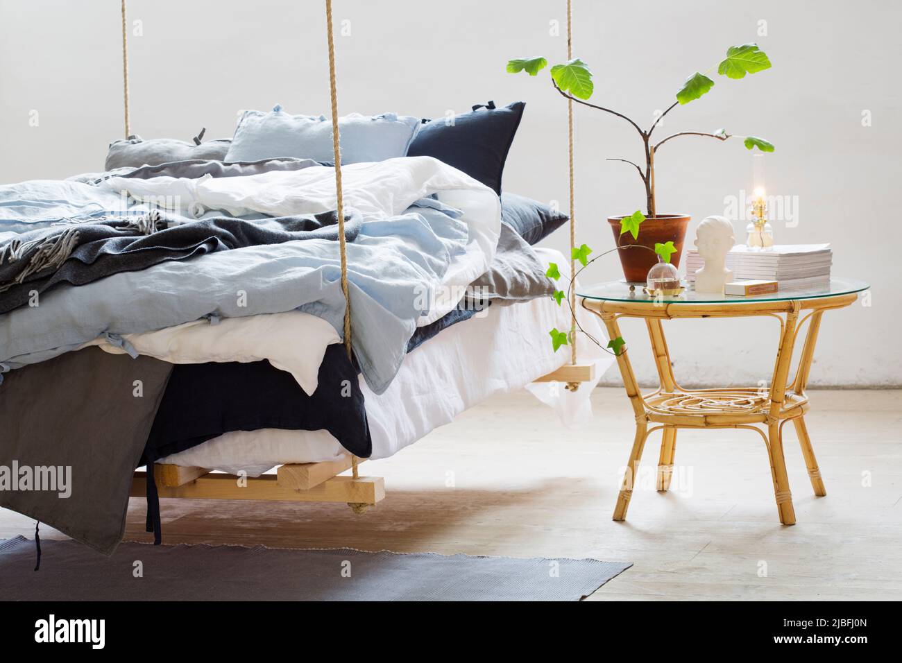 Hanging bed and bedside table Stock Photo