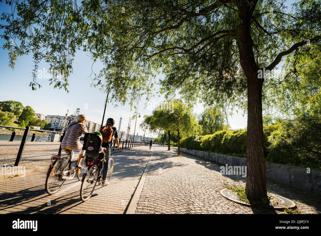 Cyclists by waterfront in Stockholm, Sweden Stock Photo