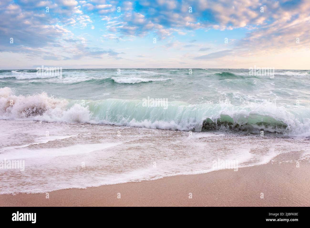 seascape with waves crashing the beach at sunrise. beautiful summer scenery  at the sea in morning light Stock Photo - Alamy, image size:1300x956