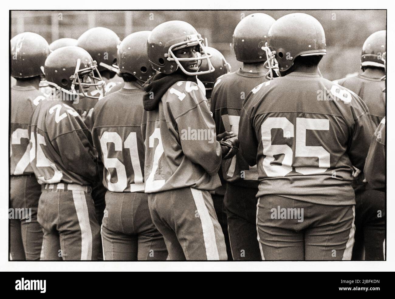 FACE IN THE CrOWD. Member of the John Jay High School football team at a 1982 practice session in Prospect Park, Brooklyn, New York City. Stock Photo