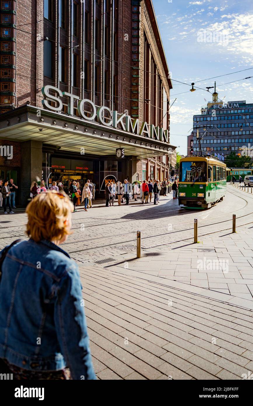 Pedestrians and tram on city street in Helsinki, Finland Stock Photo