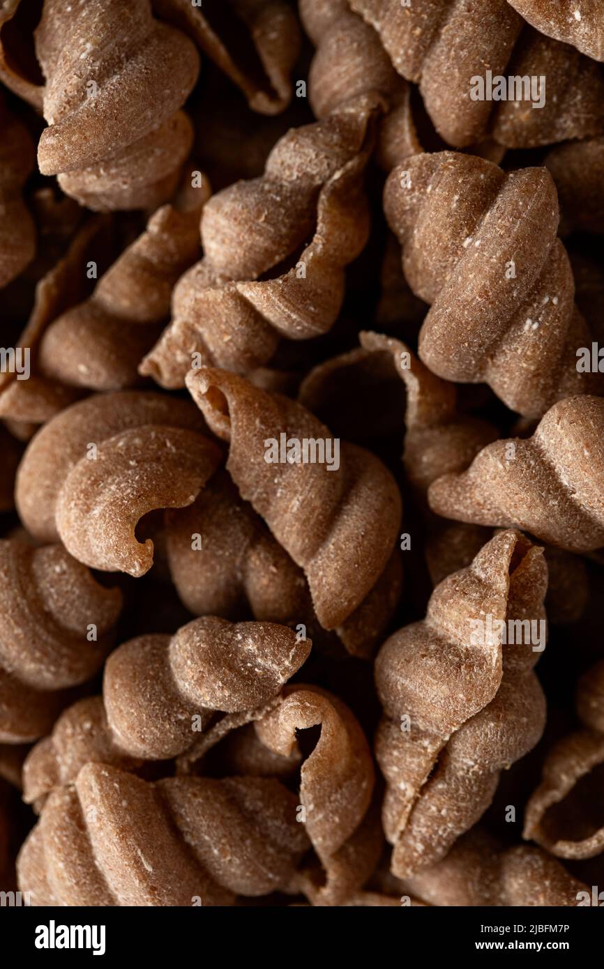 Close-up view of raw spelt snail pasta Stock Photo