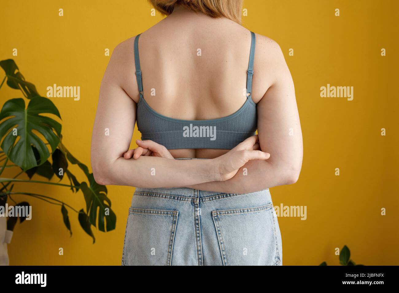 Back view of unrecognizable fat plump plus-size overweight woman