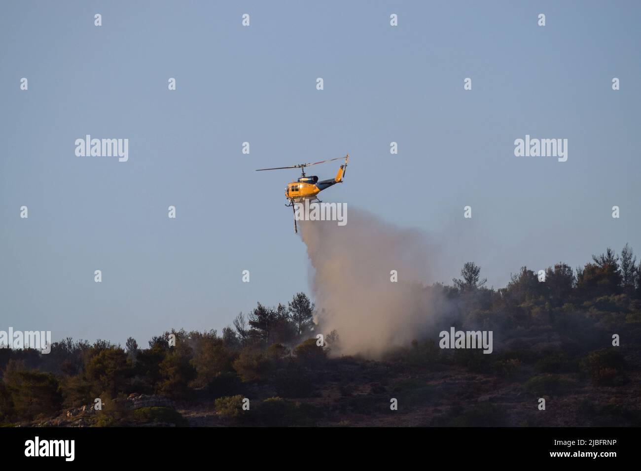 A firefighting McDermott Aviation N254SM helicopter operates in the region of Voula  southern suburb, as wildfire blazes threatening surrounding homes. Athens, Greece, 4 June 2022. Credit: Dimitris Aspiotis / Alamy Stock Photo