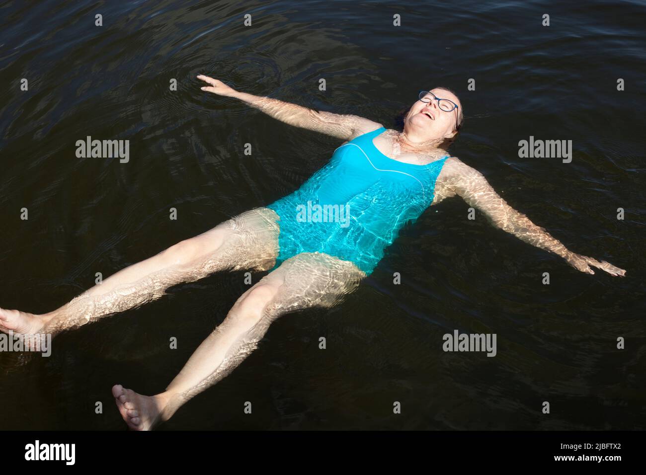 Mature woman swimming in lake Stock Photo