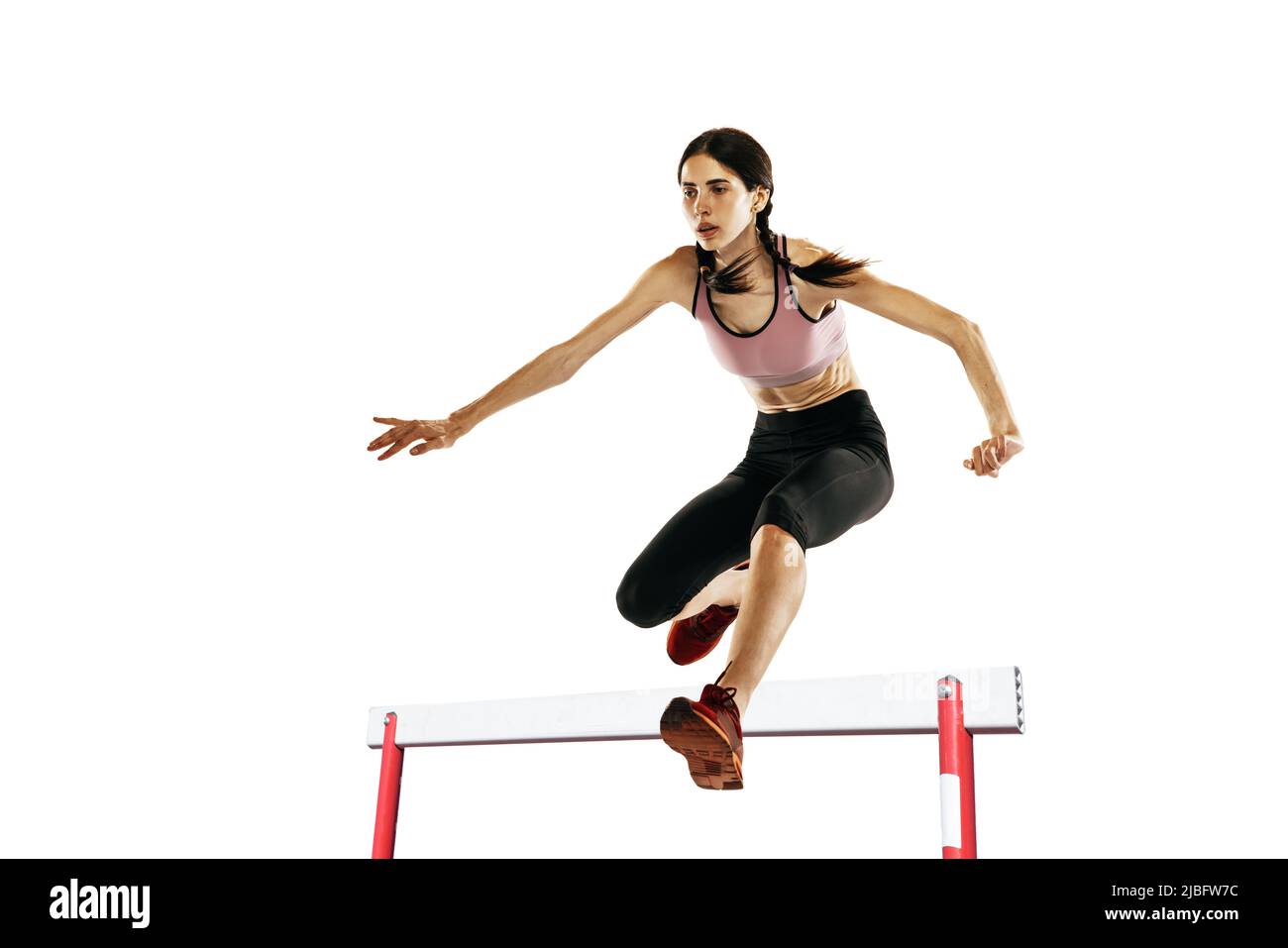 Young caucasian woman running, jumping isolated on white studio
