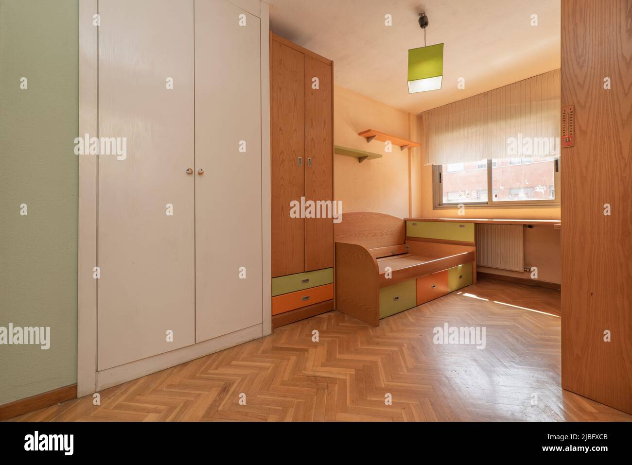 Youth bedroom with pine wood furniture with matching shelves, desk and