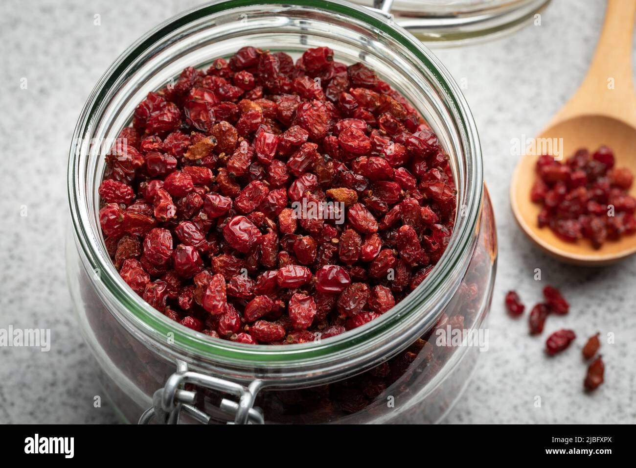 Glass jar with dried red Iranian barberries close up Stock Photo