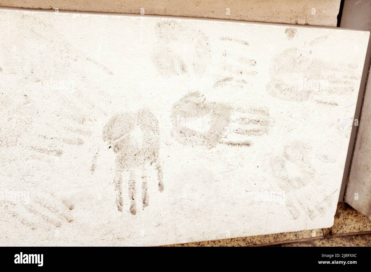 Dirty hand prints on a concrete wall Stock Photo
