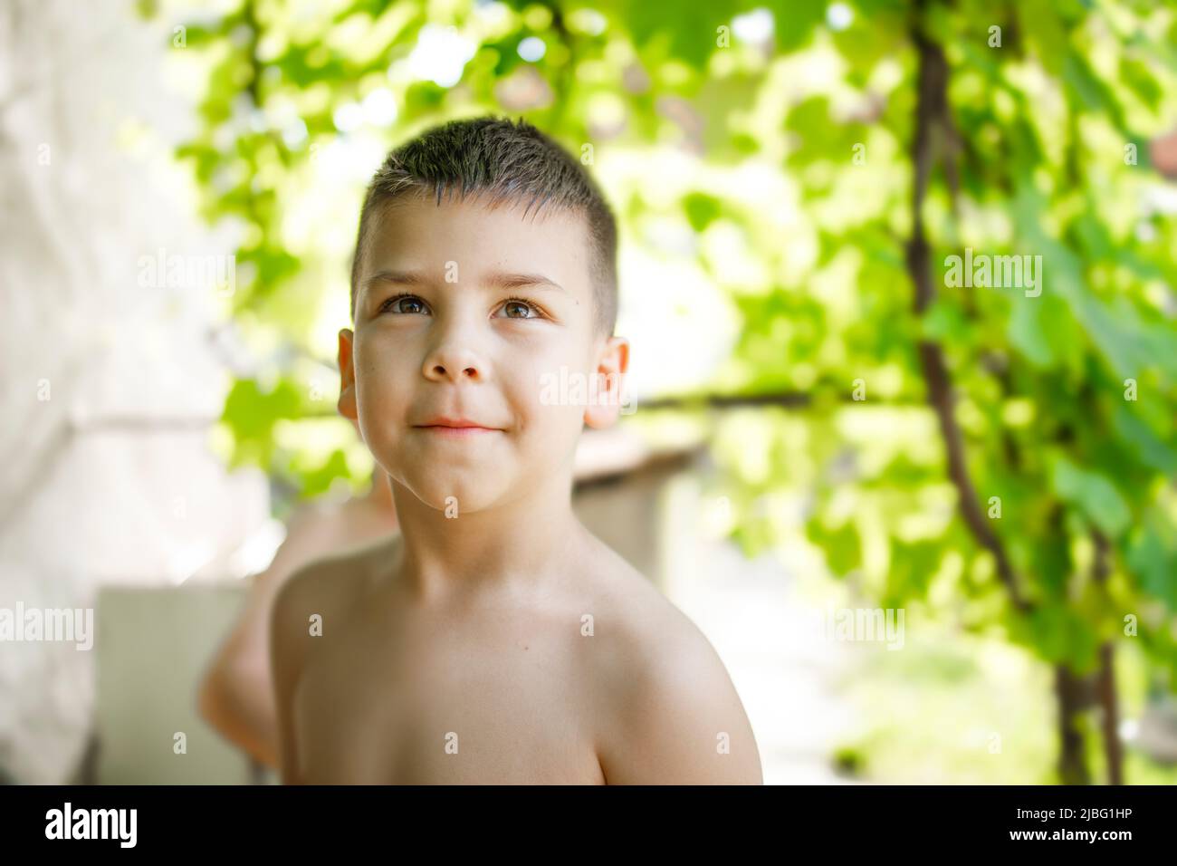 Face of a young boy smiling and enjoying hot summer weekend Stock Photo