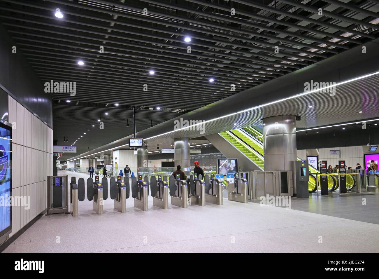 London, UK. New Elizabeth Line (Crossrail) station at Canary Wharf. Shows ticket barriers and escalators from entrance level. Stock Photo