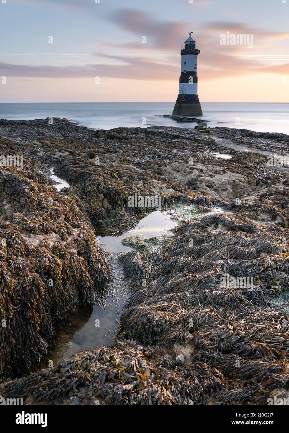 Sunrise at Trwyn Du Lighthouse, Penmon, Anglesey, UK. 27 May 2022. Photograph by Richard Holmes. Stock Photo