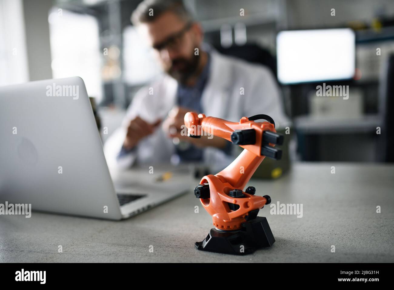 Robot arm industrial miniature figure on table in front of robotics
