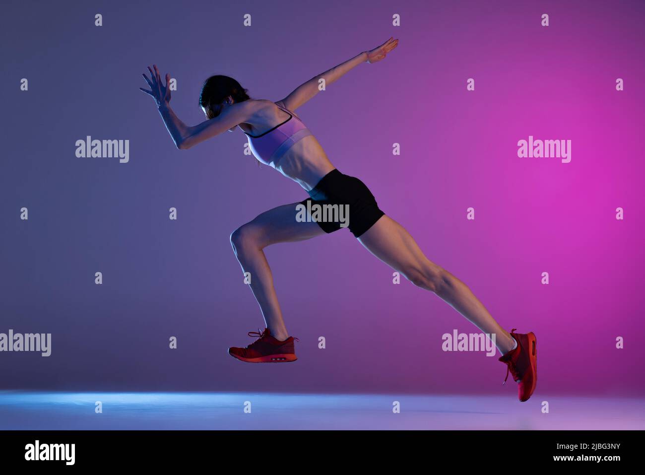 One young muscular girl, female runner or jogger training isolated on