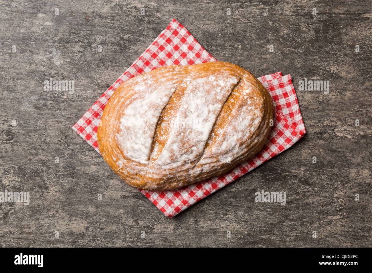 Freshly baked delicious french bread with napkin on rustic table top