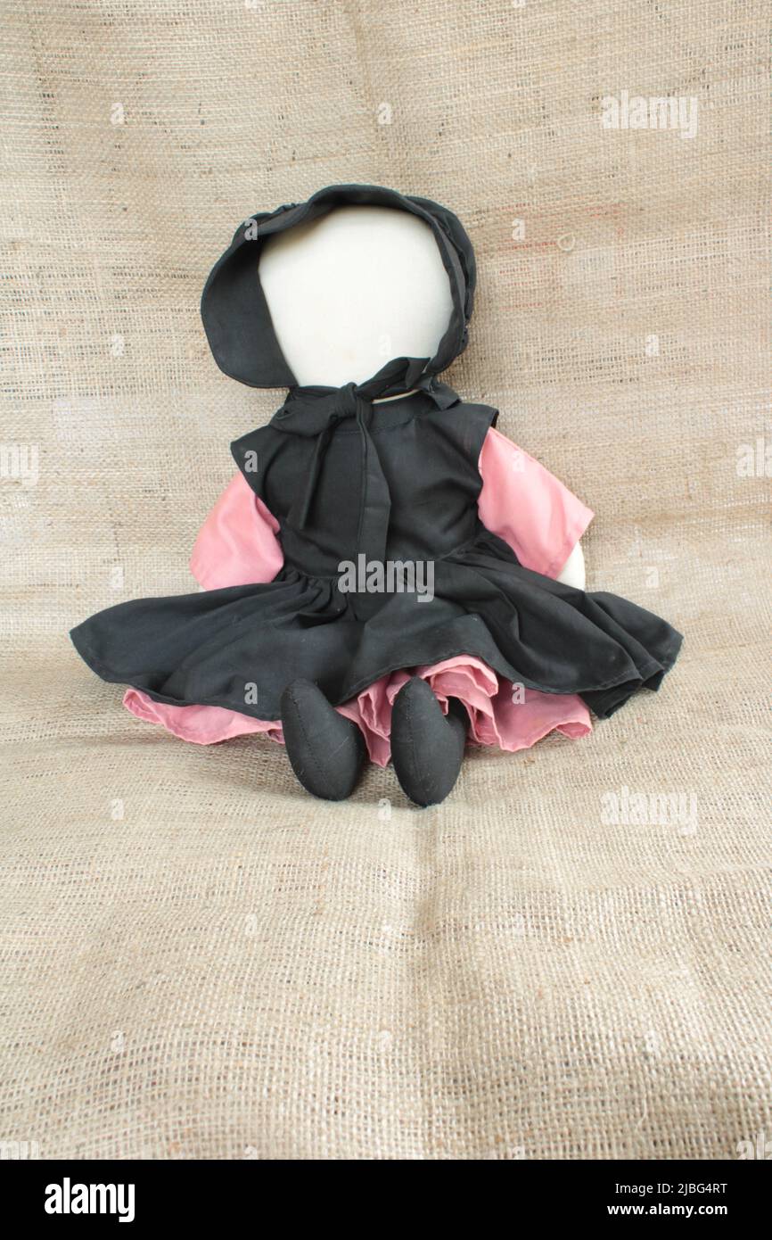 Amish doll, traditional faceless female Amish doll in traditional clothes with copy space. Stock Photo