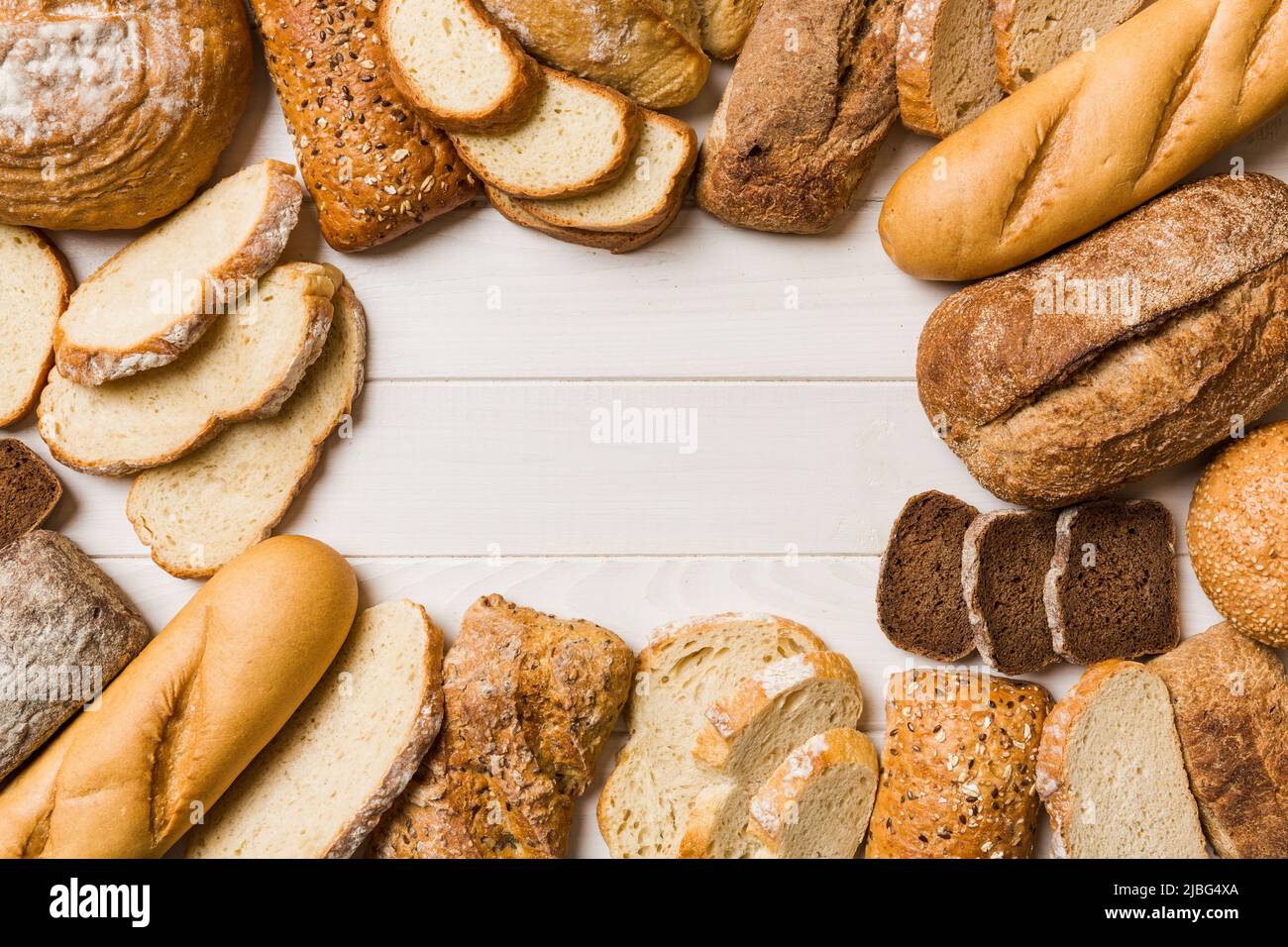 Homemade natural breads. Different kinds of fresh bread as background, top view with copy space