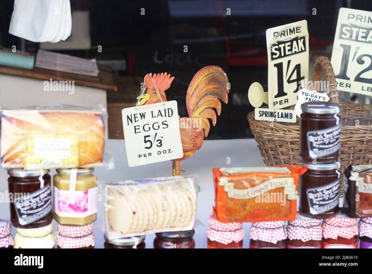Traditional window display with preserves, cakes and biscuits in Staithes, Yorkshire, UK Stock Photo