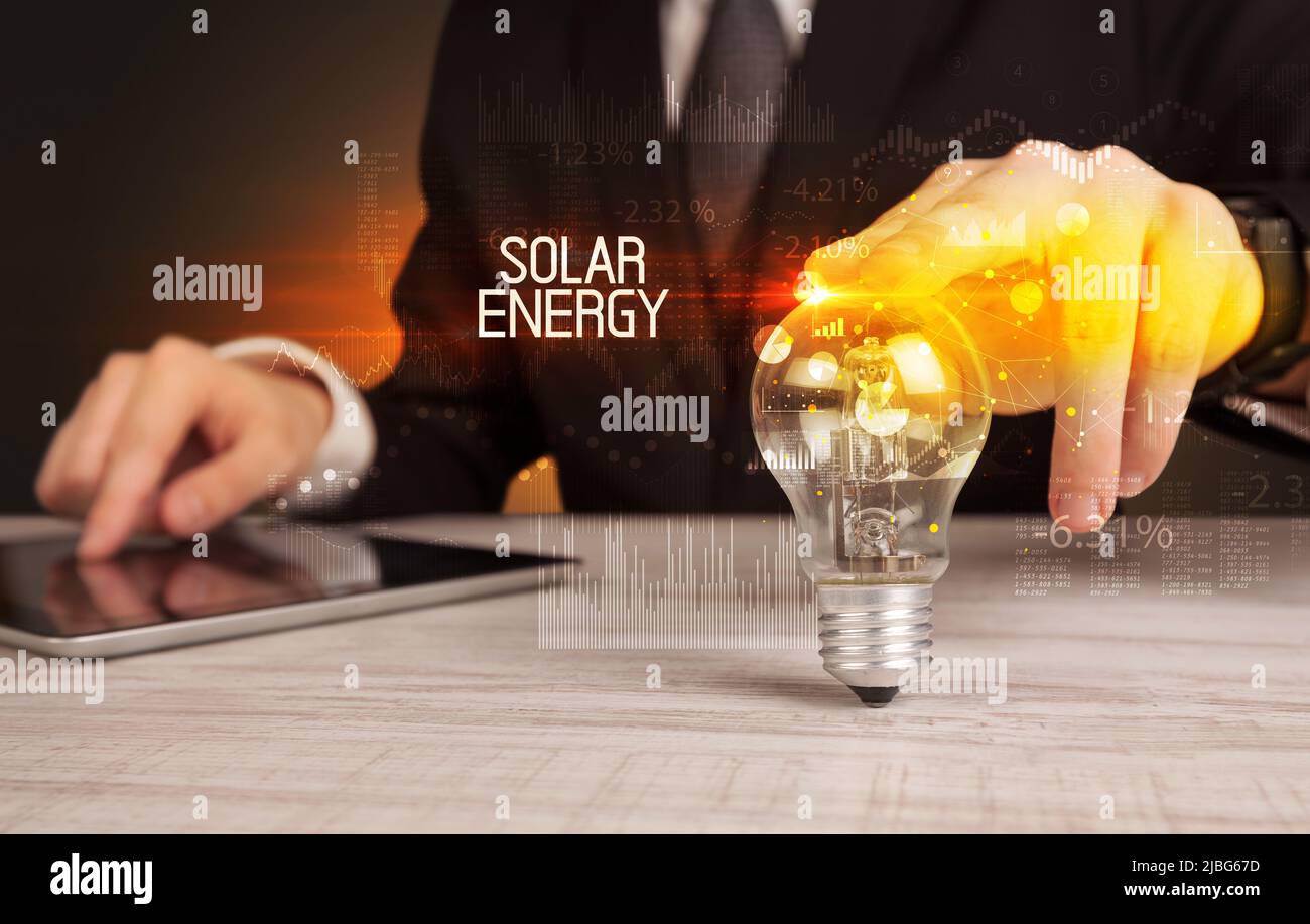 Businessman holding a lightbulb concept Stock Photo - Alamy