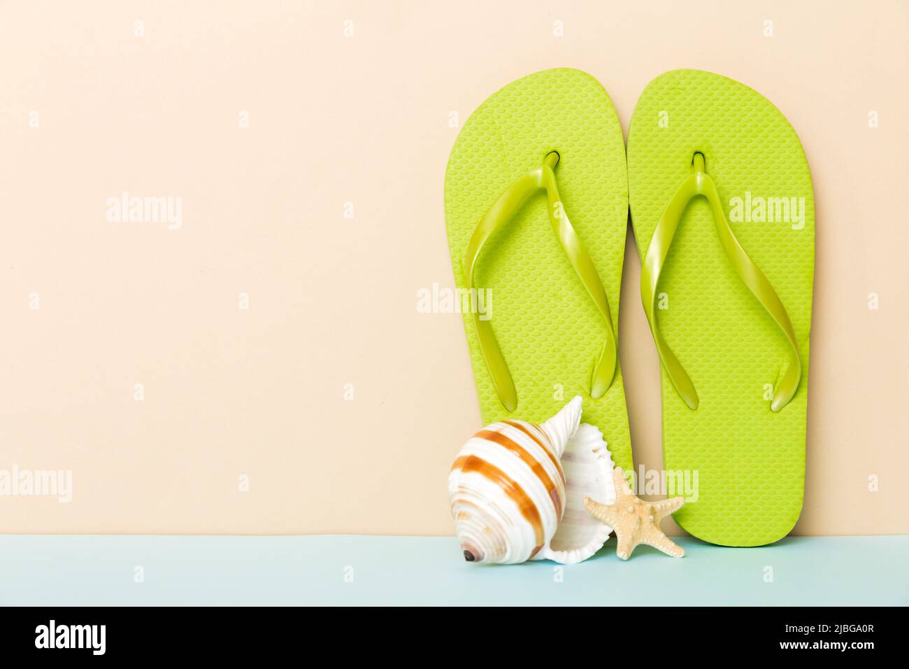 Beach accessories. Flip flops and starfish on colored background. Mock ...