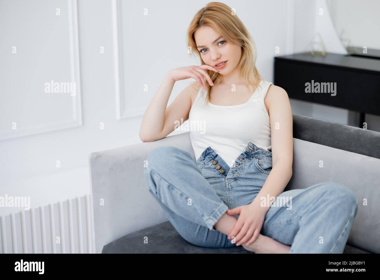 Young woman in jeans barefoot hi-res stock photography and images - Alamy