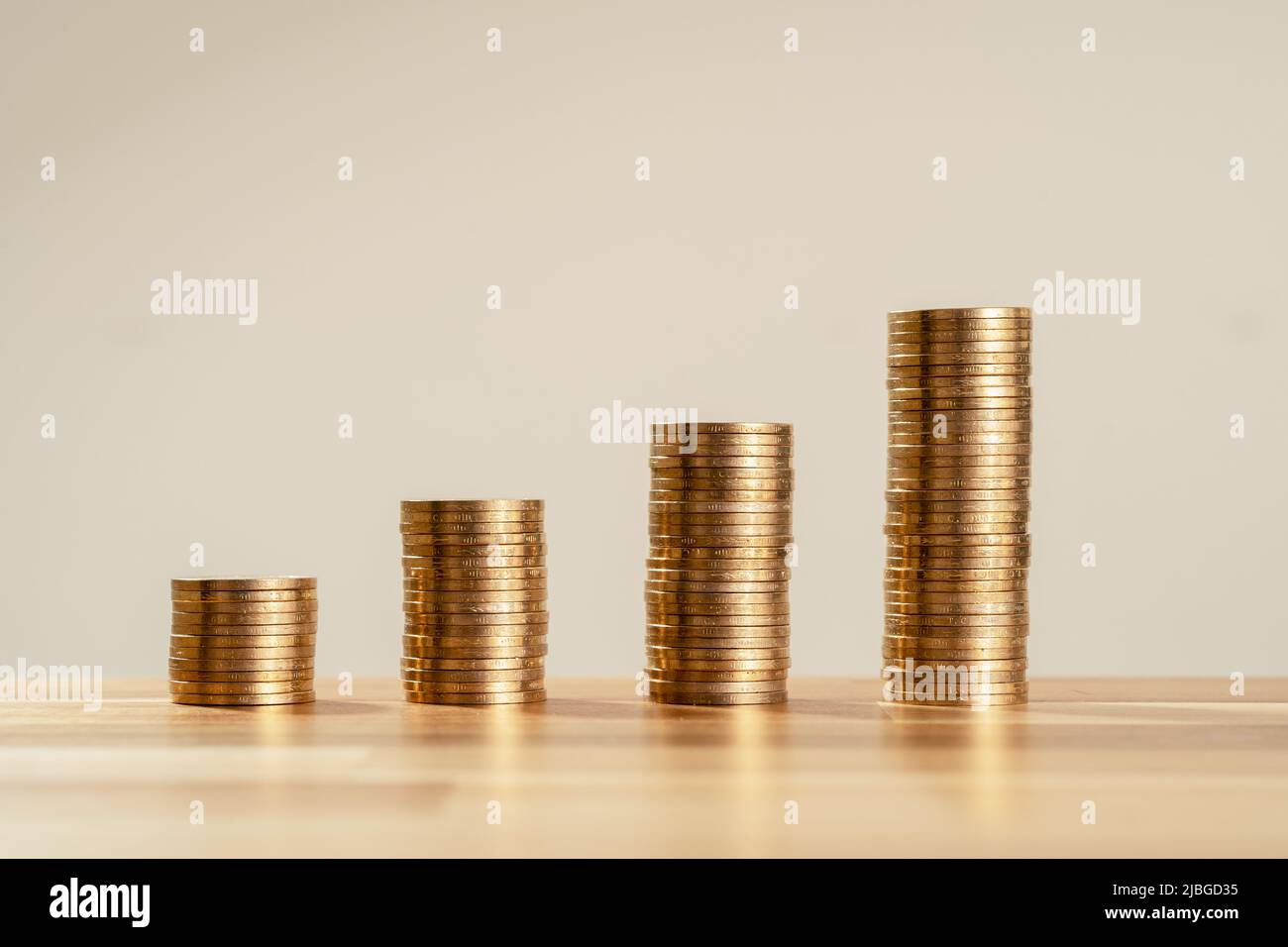 Close up Photo of constantly increasing coins on isolated background. Concept of rising money and climbing investment of new startup. Stock Photo