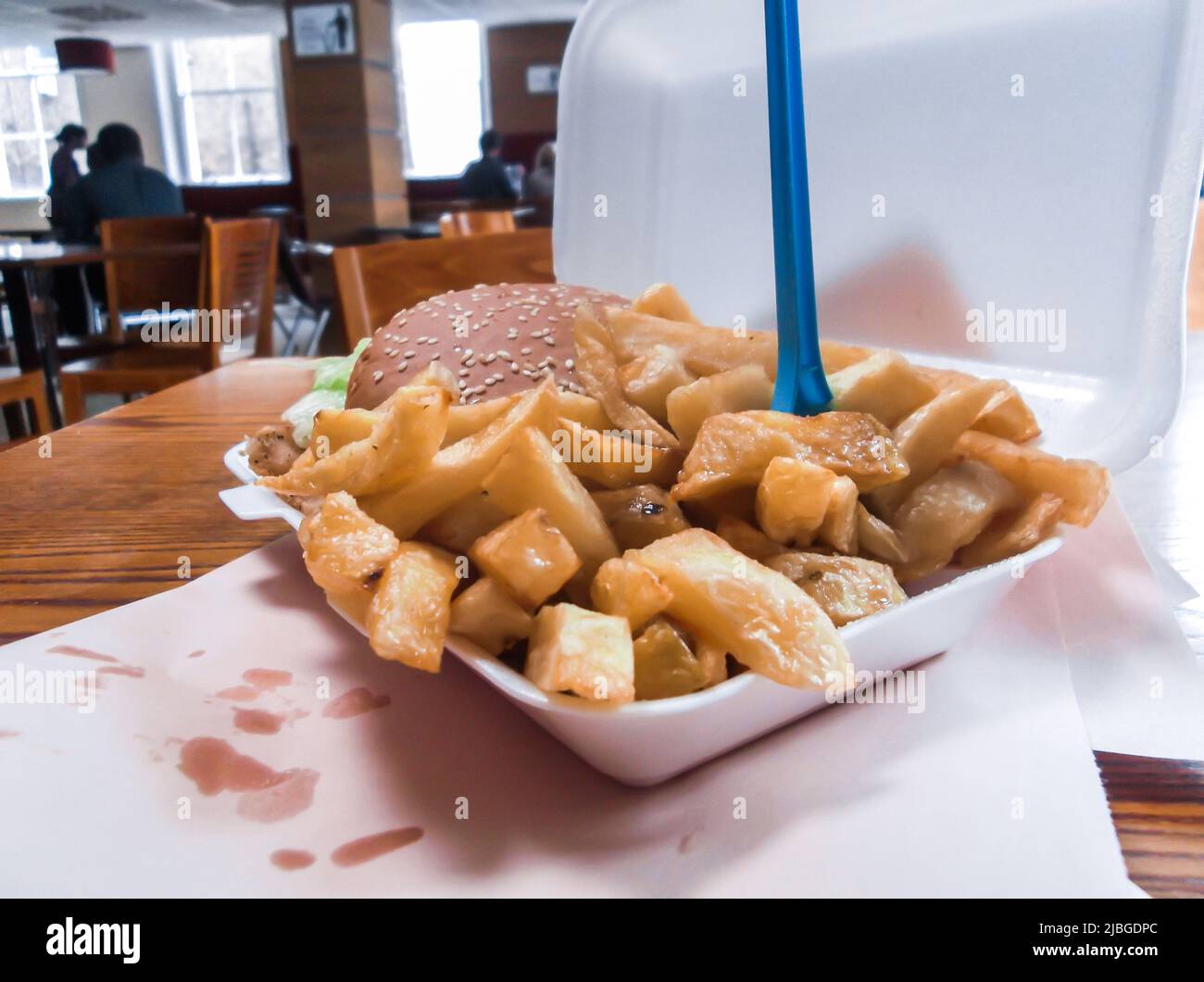 The image of chips (french fries) and chicken burger in local fast food