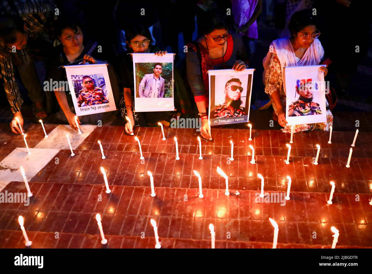 Members of Sommilito Sangskritik Jote organisation participate in a candlelight vigil in remembrance of the victims of the fire that broke out in an inland container depot in Sitakunda, in Dhaka, Bangladesh, June 6, 2022. REUTERS/Mohammad Ponir Hossain Stock Photo