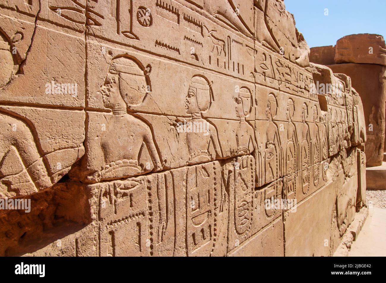 Old Egypt hieroglyphs carved on the stone wall in The Karnak Temple Complex, Luxor, Egypt (ancient Thebes). Stock Photo
