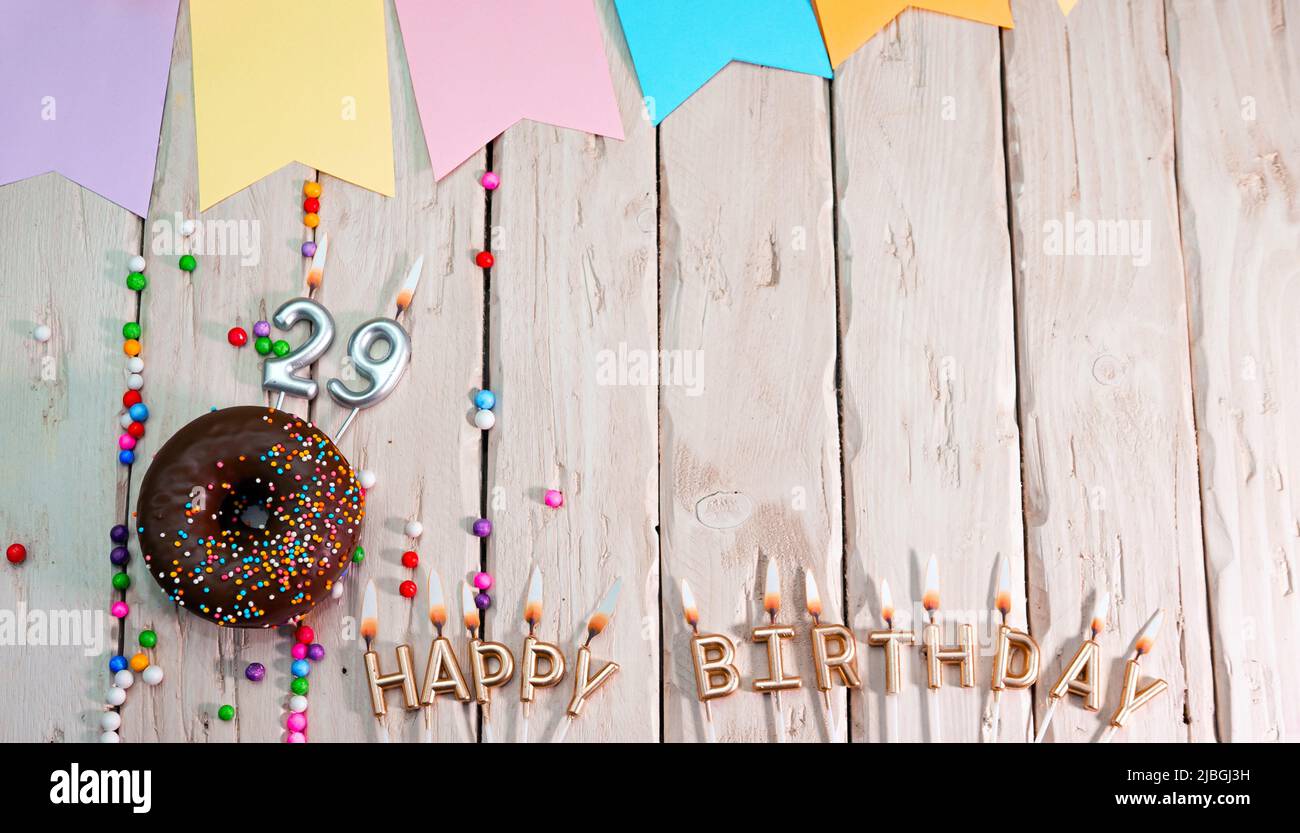 Birthday with number. Donut on the festive table. Happy birthday congratulations top view. Happy birthday card with beautiful decorations on a white Stock Photo