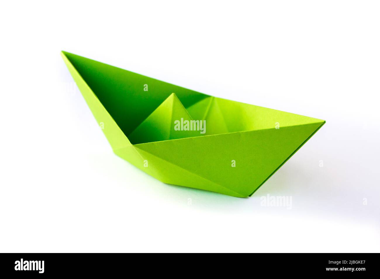 Green paper boat origami isolated on a blank white background. Stock Photo