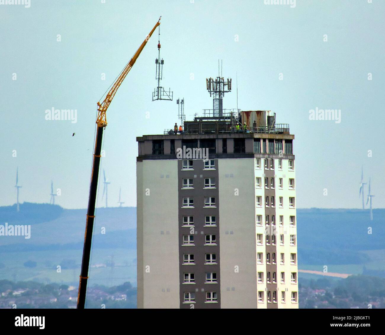 Glasgow, Scotland, UK 6th June, 2022.  Despite the health concerns and the targetting of the poor Scotstoun council towers get 5g aerial installed with the aid of a massive craner. Credit Gerard Ferry/Alamy Live News Stock Photo