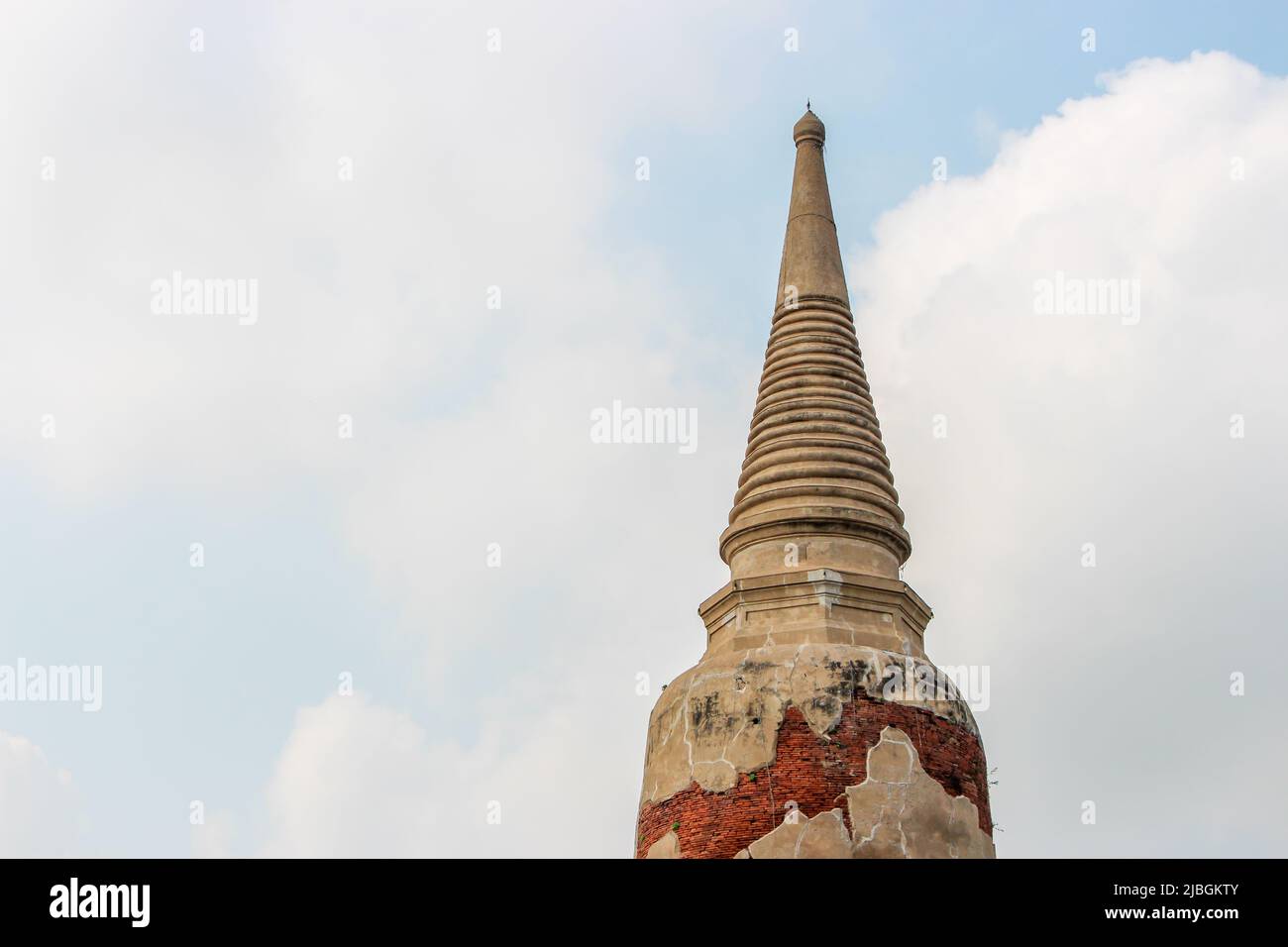 The close up image of old ancient stupa (Chedi Wat Sam Pluem) in cloudy sky, Ayutthaya, Thailand Stock Photo