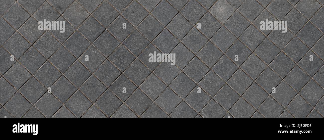 Sidewalk of square paving stones seen from above, widescreen image Stock Photo