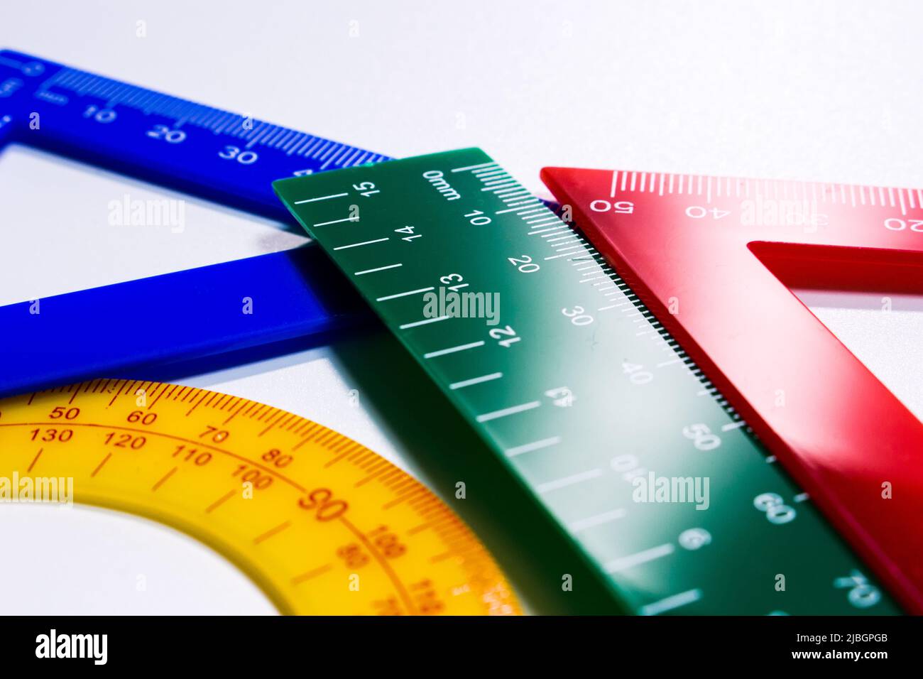 Concept image of colourful rulers and protractor in white background