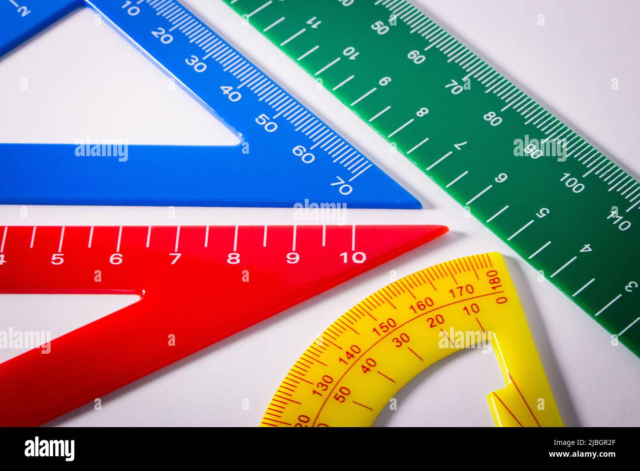 Concept image of colourful rulers and protractor in white background