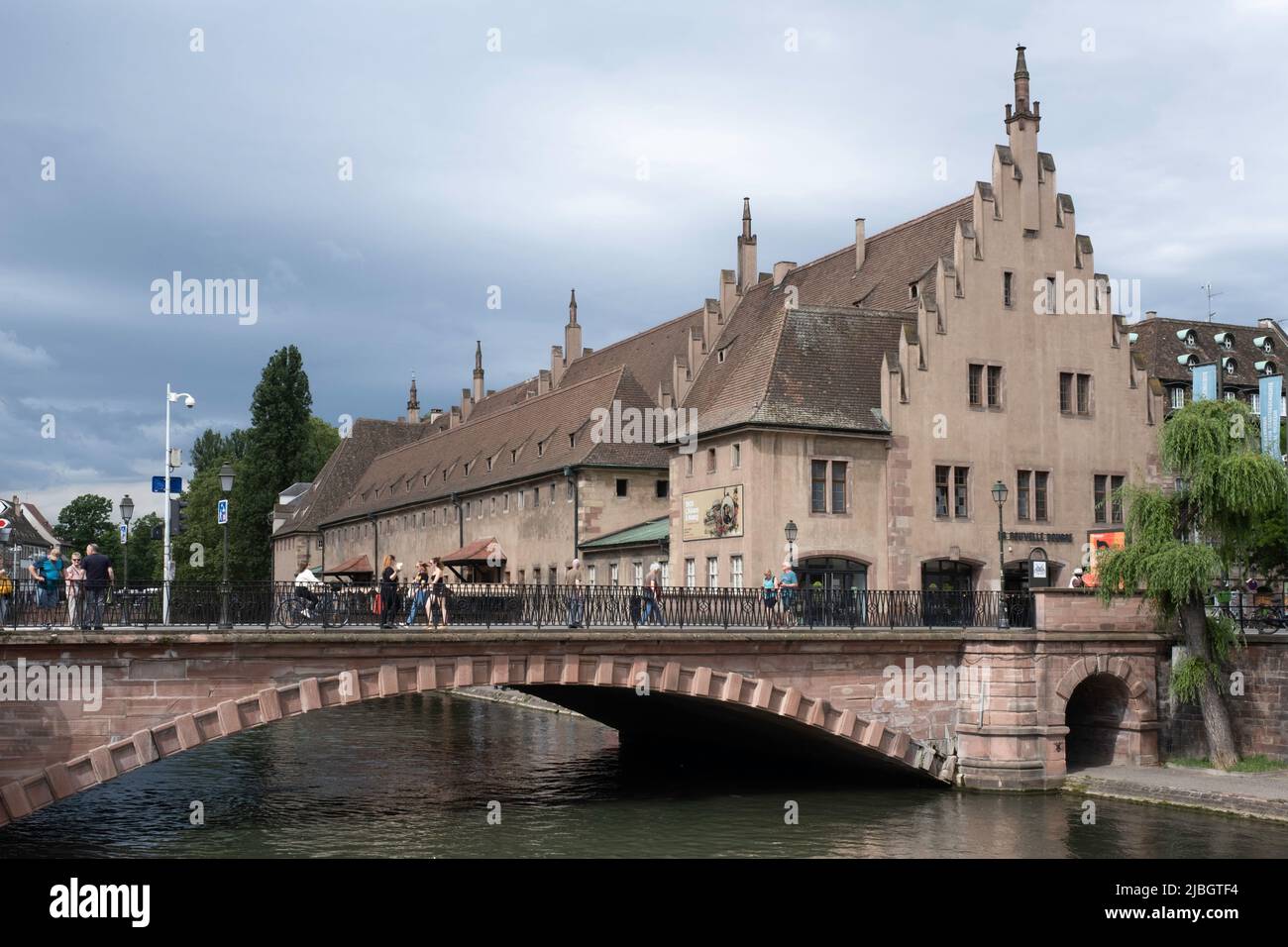 Historical building of the old customs with bridge on the embankment of the Ill river in Strassbourg. Now it's the farmers market 'La Nouvelle Douane' Stock Photo