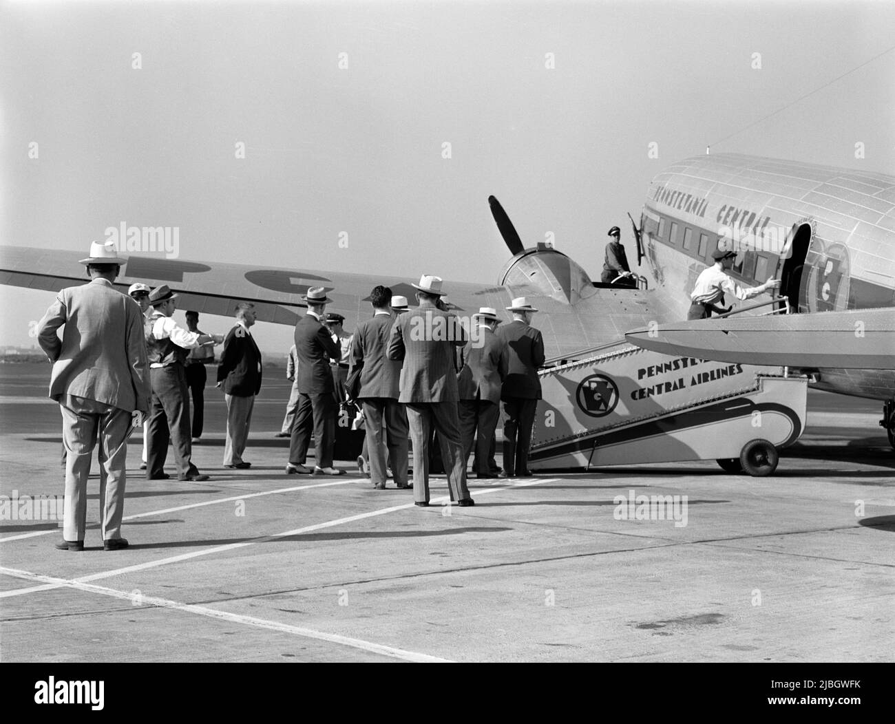 Vintage photo circa 1941 of passengers boarding a Douglas DC3 airliner operated by Pennsylvania Central Airlines at Washington DC Stock Photo