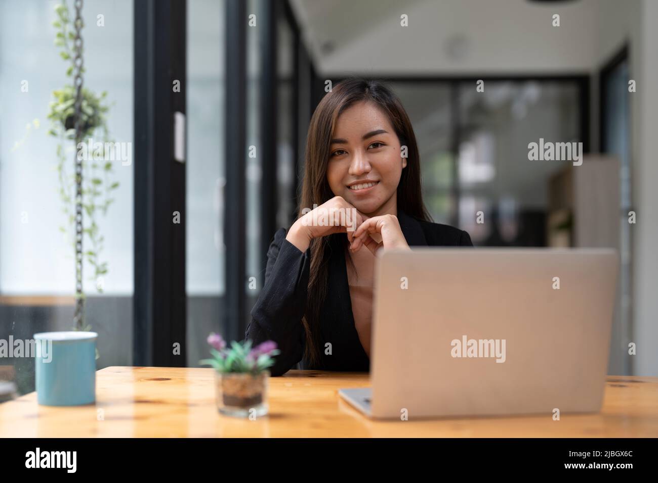 Portrait of young asian woman freelance online working from home with laptop computer. Stock Photo