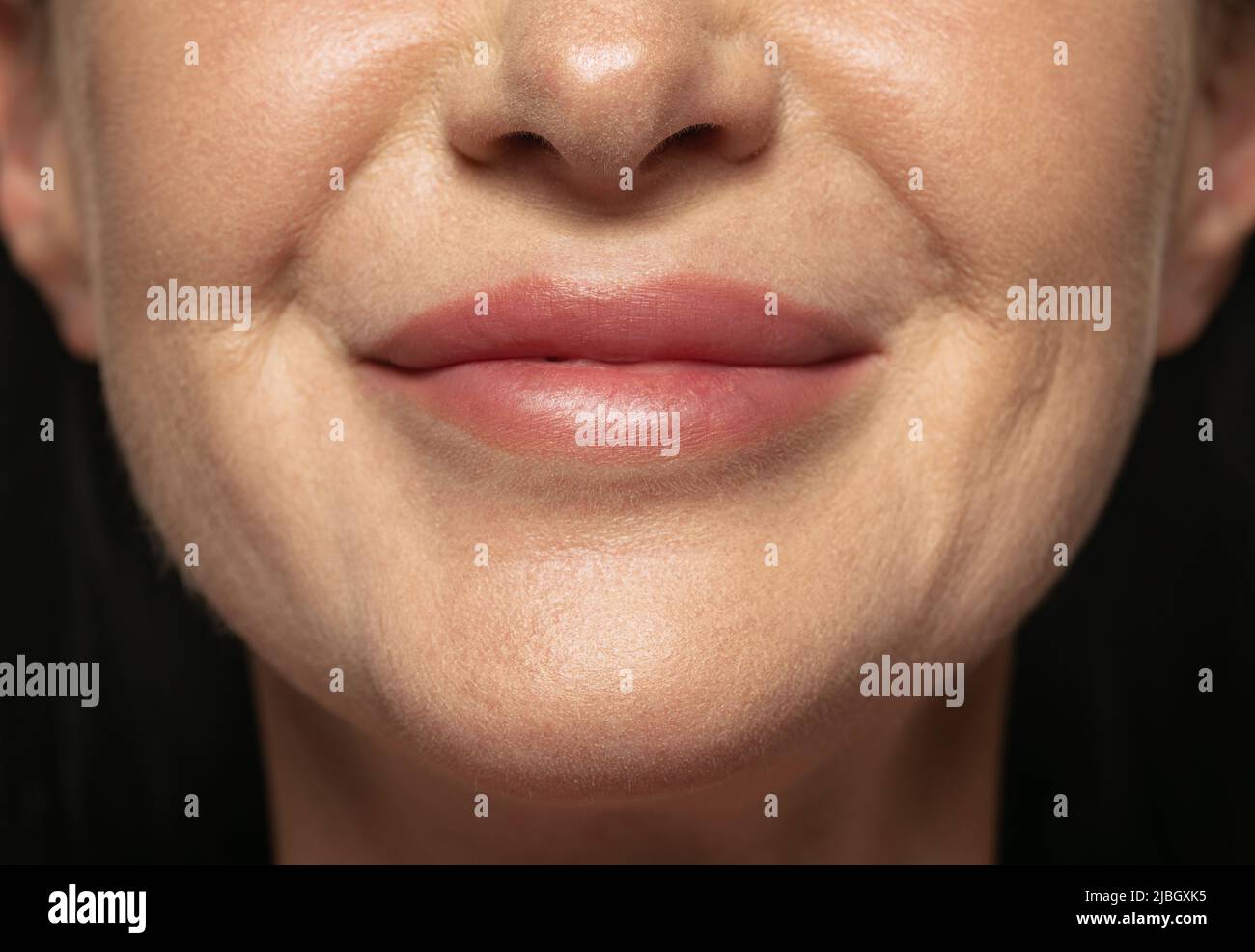 Close-up middle age woman's lower face with first wrinkles. Female ...