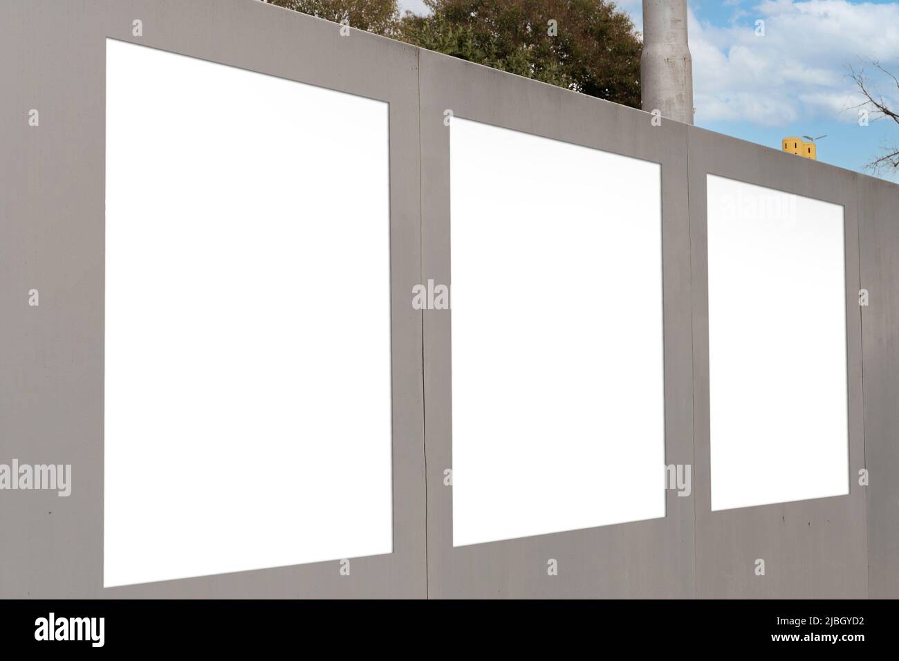 Concrete wall with three blanks for advertisements Stock Photo