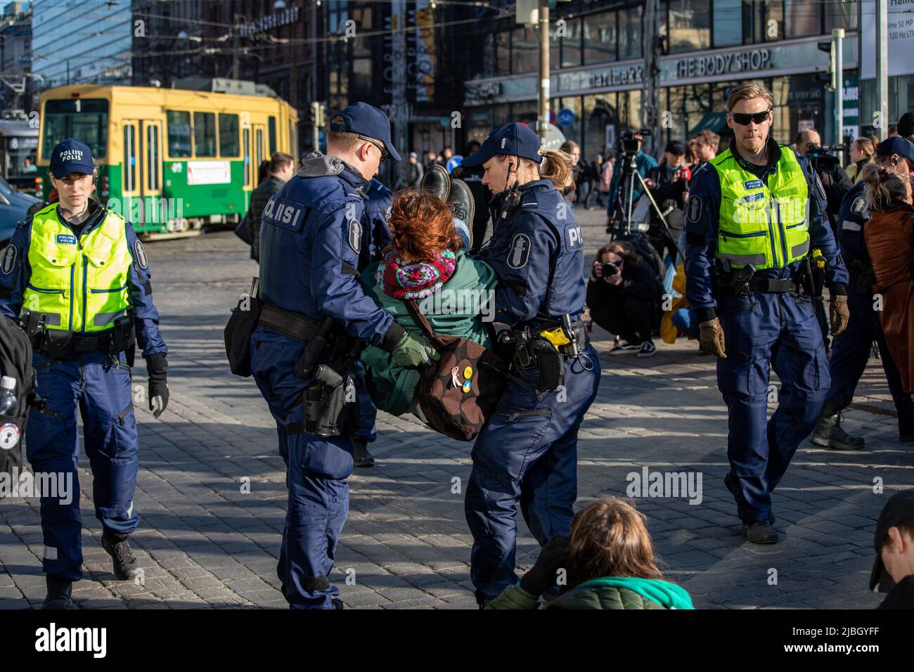 Street blocking protester being arrested and carried away by police at Elokapina's  demonstration in Mannerheimintie, Helsinki, Finland Stock Photo