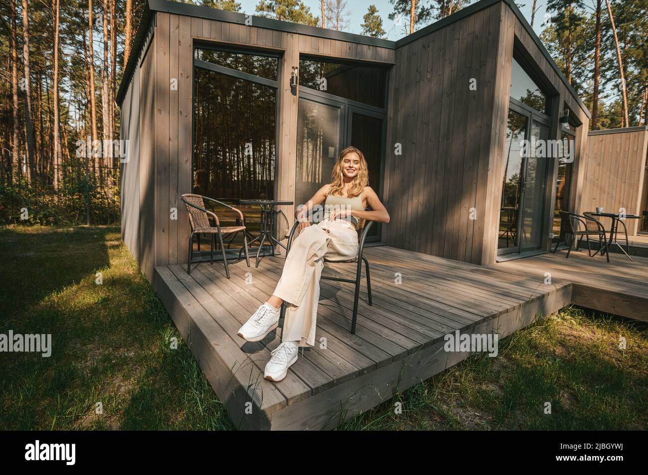 Woman sitting on porch veranda hi-res stock photography and images - Alamy