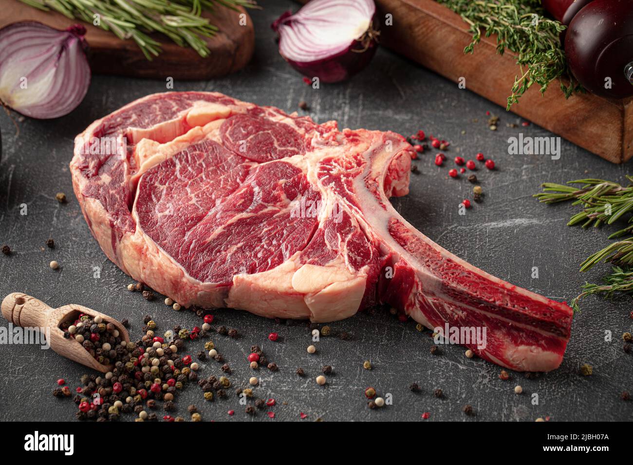 Side view on raw beef american tomahawk steak Stock Photo