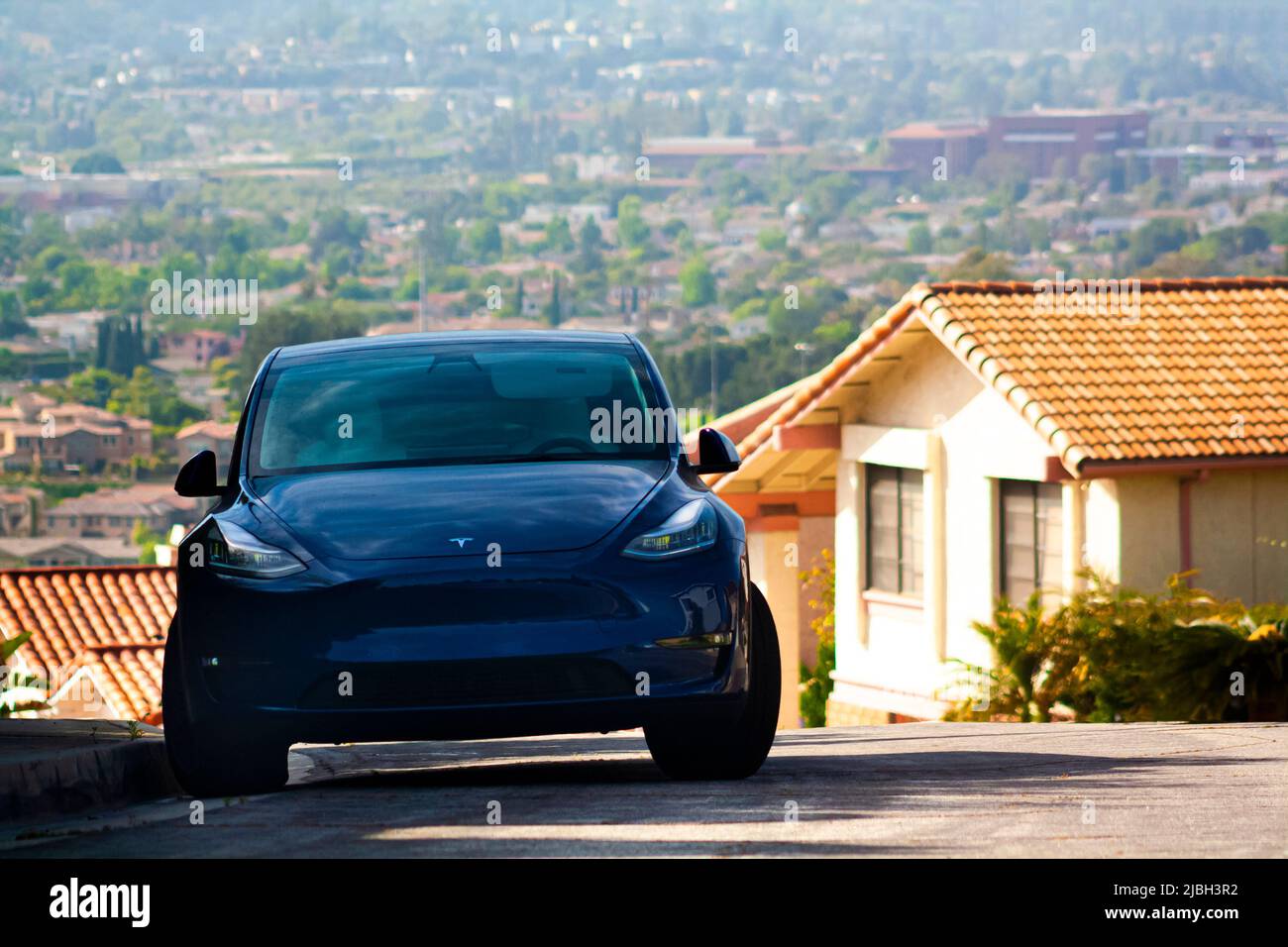 A Tesla electric car in a smog filled valley Stock Photo