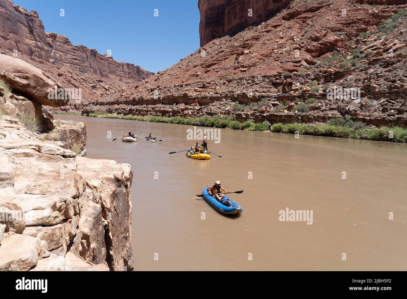 River explorers and tourists navigate their boats, rafts, paddle boards 