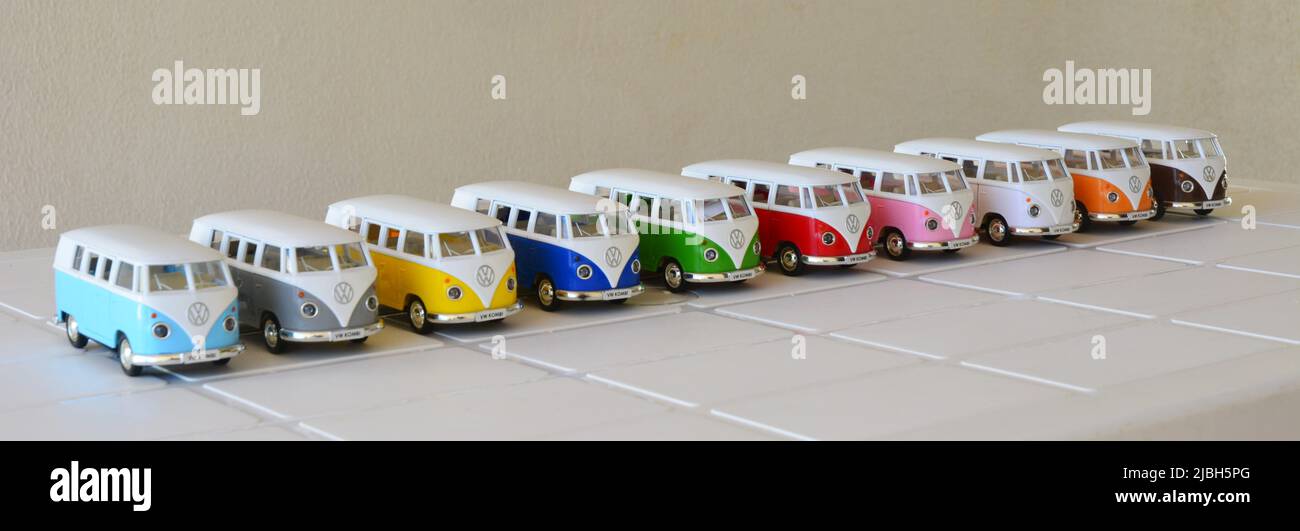 Diecast, Iron miniature, Vans of various colors, Brazil, South America, top view, selective focus on white table on white background, lined up, inten Stock Photo