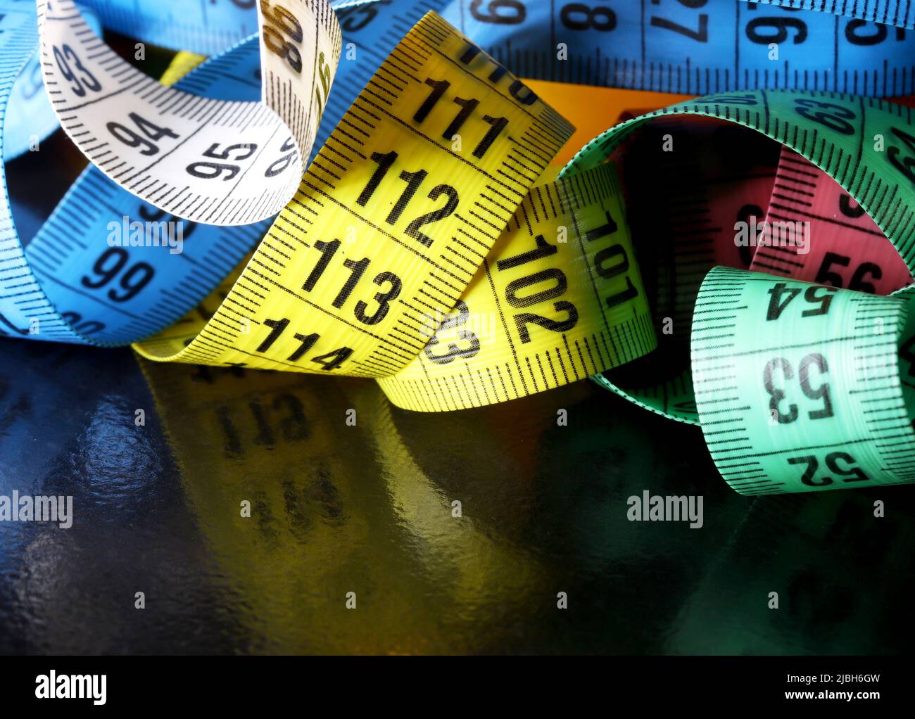 measuring tape on a black background Stock Photo - Alamy
