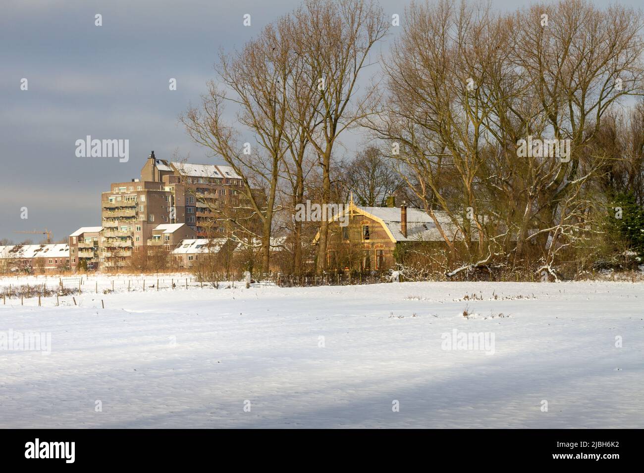 Landscape winter scenery of a farm and other buildings surrounded by ...